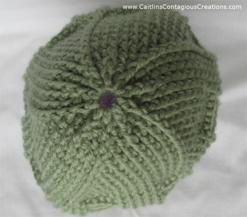 Spiral Star Basket Weave Beanie Crochet Pattern. This free, easy crochet design is a great winter hat! It is thick and warm with a beautiful spiral star cabling design on top. | Caitlin's Contagious Creations